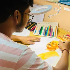 Me and my love, my art. Here I am, deeply focused on a color pencil commission, with my ring light and tools. This is my happy place.