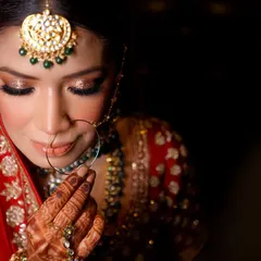 A bride's quiet moment of reflection before she walks down the aisle. I focus on capturing the delicate details, from the sparkle in her eyes to the intricate henna, telling a story of anticipation and beauty.