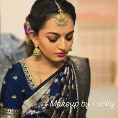 This is the classic South Indian festive look I created for a client's family ceremony. The focus is on flawless skin, defined eyes with a gold shimmer, and a bold pink lip to complement her royal blue silk saree.