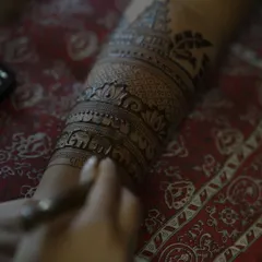 A macro shot showing the fine lines of a temple and elephant band being applied with precision.
