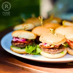 Our mini burgers are a crowd-pleasing favorite. These perfectly crafted sliders, served on a clean white plate, are an example of how we present even casual foods with a touch of gourmet elegance.