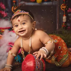 Celebrating culture and childhood joy with a themed Janmashtami photoshoot. This little one, dressed as Krishna, brings so much playful energy. I love creating these vibrant, imaginative setups that honor our traditions and capture your child's delightful spirit.