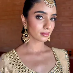 A direct portrait showing the beautiful symmetry of the makeup. The defined brows and clean eye makeup frame her face perfectly.