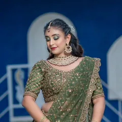 This bride has paired her green lehenga with a simple and elegant Kundan choker. It's a great way to add a touch of tradition to a modern outfit.