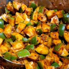 A close-up of my classic Kacchi Keri pickle in the making. You can see the fresh, green mango chunks getting coated in my homemade masala mix. This is pure, simple, and delicious homemade achaar.