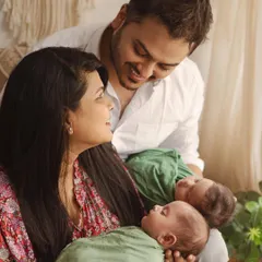 Look at the way these new parents are gazing at each other and their newborn twins. My goal in a newborn family portrait session is to capture not just the baby, but the love that fills the entire room. These are the first moments of your new family story.