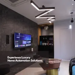 Here we showcase a complete luxury home automation solution in a living area. The setup includes a large-screen TV, discreet speakers, and custom lighting, all working together to enhance the living experience.