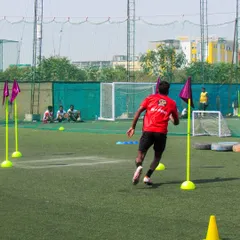 A player sprints through the agility poles in the Tiebreakers Challenge. This event is designed to test technical ability while raising funds for a good cause.