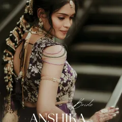 An elegant portrait highlighting the bride's stunning attire and hairstyle. The focus on her embroidered blouse and traditional braided hair makes for a beautiful and detailed bridal shot.