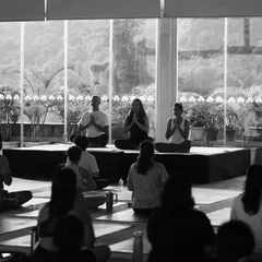 A black and white shot of our community in meditation during the International Yoga Day event. The practice continues to shape, heal, and connect us.