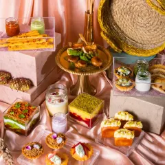 A lavish festive spread featuring a variety of sweet and savory bites. The use of different heights, textures, and a cohesive color palette creates a visually stunning display.