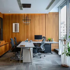 For this cabin, I went with warm wood paneling to cover the walls, creating a rich, enveloping feel. The minimalist desk and modern pendant light keep the space feeling clean and focused, perfect for a key decision maker.