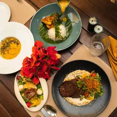 A vibrant spread of our Mediterranean-inspired dishes, featuring fresh salads, grilled meats, and colorful curries, perfect for a shared meal.
