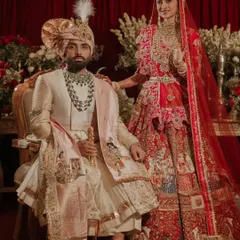A wedding portrait is a legacy. I work with the finest photographers to stage and capture regal moments like this, ensuring the couple's attire, the opulent floral backdrop, and the overall composition reflect a story of timeless elegance.