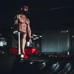 A moment of focus before a set of sledgehammer swings. Mental preparation is just as important as physical readiness in high intensity training.