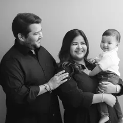 A classic family portrait in black and white, showcasing the beautiful smiles and easy connection between these three.