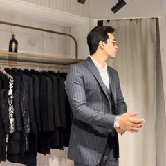 A side profile of a charcoal grey pinstripe three-piece suit. The waistcoat adds a layer of formality and sophistication, perfect for important meetings or corporate events.