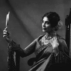 A black-and-white version of a couture shoot, adding a layer of classic, old-world charm. The monochrome tones emphasize the emotion and the intricate details of the jewelry and embroidery.