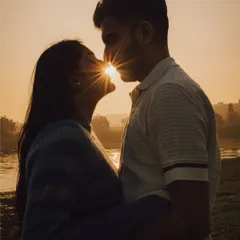 A kiss that seals the deal, with the sun creating a perfect starburst between them. We love playing with natural light during golden hour for pre-wedding shoots to create truly magical and romantic couple portraits.