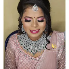 I love how the soft pink tones in her makeup perfectly match the delicate colour of her reception lehenga.