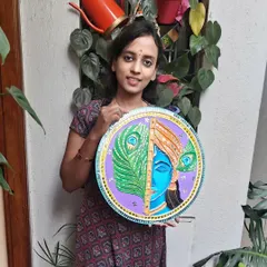 This is a piece of Krishna Lippan art, a traditional mud and mirror work technique from Gujarat. I created this 17-inch wall hanging on a wooden board, combining intricate clay textures with reflective mirrors to bring a sense of peace and divinity to your home.