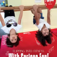 Flipping into fitness is all about smiles and support. Here, two friends build upper body strength and coordination on the gymnastics bar, learning that getting strong can be full of giggles.