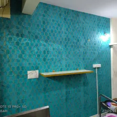A vibrant teal wallpaper with a gold-embossed honeycomb pattern. The metallic details add a touch of luxury.