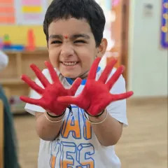 The pure joy of creating something with your own hands. This little boy's excited expression says it all about our fun-filled art sessions.