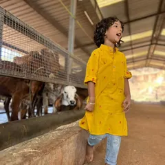 Being kind to all beings is a lesson I cherish. This little boy is wearing our yellow handloom cotton kurta while visiting a goshala, looking comfortable and stylish.