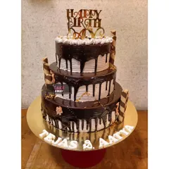 A grand three-tier chocolate drip cake. This towering creation is perfect for large birthday parties or events, combining classic looks with indulgent flavor.
