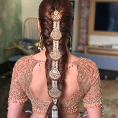 Advanced braiding is a key part of my curriculum. This intricate bridal braid, decorated with traditional Anand Karaj jewelry, demonstrates the level of detail and artistry my students learn to master, allowing them to cater to high-end bridal clients.