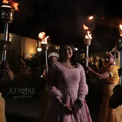 The bride's radiant smile as she makes her grand entrance, surrounded by the warm glow of torches. We love creating these picture-perfect moments that are filled with emotion and beauty.