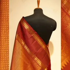 A rich maroon Kanjivaram with a wide gold zari border, a timeless piece for any bridal trousseau.