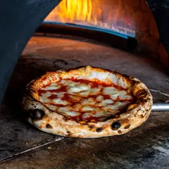 There's nothing like a pizza fresh from a wood-fired oven. I focused on capturing the intense heat, the perfectly charred crust, and the bubbling cheese to convey that unmatched flavor and authenticity.