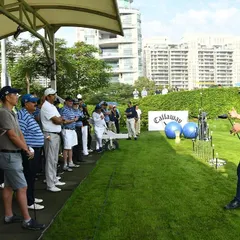 A group of engaged golfers listens intently during a coaching clinic on our driving range. We offer lessons and clinics for every skill level, led by our team of experienced professionals.