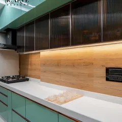 A glimpse into a sleek, modern modular kitchen. We used a refreshing mint green laminate for the cabinets, paired with a clean white countertop and warm under-cabinet lighting to make the space both stylish and highly functional for daily cooking.