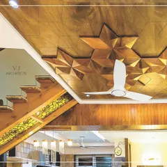 This unique false ceiling design uses 3D geometric wooden stars, creating a visually complex and artistic feature. It demonstrates our love for playing with shapes and materials to create one-of-a-kind interiors.
