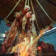 A powerful shot of the couple during a fire ritual, their hands extended over the sacred flames. I aim to capture the spiritual intensity and visual drama of these important wedding traditions.