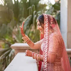 A candid shot of the bride on the balcony, waving happily. This captures a genuine moment of excitement and joy before the ceremony.