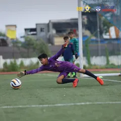 A young goalkeeper makes a diving save during a training session. We encourage our players to take leaps of faith and push their limits to achieve their goals.