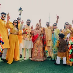 The whole squad together for the Haldi! This photo captures the bride and groom with their friends and family, all dressed in yellow and ready to celebrate with dhol beats.