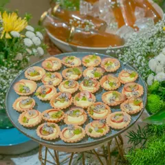 A platter of our delicate fruit tarts, filled with cream and topped with fresh kiwi, apple, and dragon fruit. These bites are a refreshing and elegant addition to any dessert table or high tea.