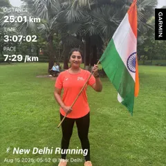 A female member after a 25km Independence Day run, holding the flag. Her dedication to both running and her country is inspiring.