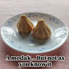 This might look like a modak, but it's not as you know it. The outer shell is a baked, buttery pie crust, offering a delightful textural contrast to the soft, sweet filling inside.