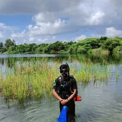Getting geared up for a training dive in the quarry. Every piece of equipment, from the fins to the regulator, is checked and double-checked. This focus on preparation ensures a smooth and safe experience for everyone.