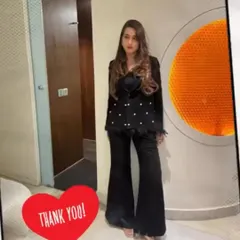 Our client looking powerful and chic in a custom-designed black pantsuit. We added pearl embellishments and feather details to the blazer for a touch of glamour, paired with flared trousers for a modern, sophisticated look.