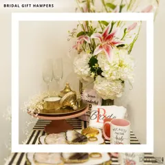 I design these bridal hampers to make the bride-to-be feel truly special. This set includes a "Because I'm the Bride" mug, a personalized t-shirt, champagne flutes, and other pampering items, all beautifully arranged on a decorative stand.
