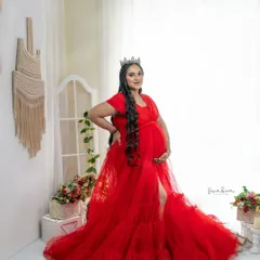 A queen awaiting her heir. Set in my bright, white studio space, this portrait uses a flowing red gown and a delicate crown to create a look of regal elegance.