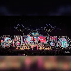 This is the scale we operate on. A full stage view from our award-winning choreography for the WOW Awards Asia 2024, featuring a massive ensemble of dancers, vibrant costumes, and a dynamic LED backdrop. We bring this level of energy to every live event.