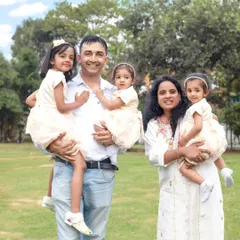 A beautiful family portrait taken in a lush green park. Outdoor photoshoots are perfect for capturing natural smiles and energetic, happy moments.